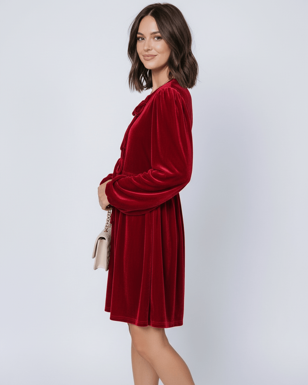 Ruby Mini Dress by Lauven, featuring a red velvet fabric, long lantern sleeves, and a flowy skirt.