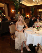 Sable Maxi Dress worn in an elegant restaurant setting by Lauven, showcasing a sophisticated square neckline and fish tail hem.