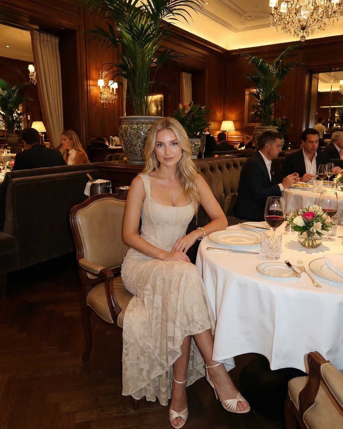 Sable Maxi Dress worn in an elegant restaurant setting by Lauven, showcasing a sophisticated square neckline and fish tail hem.