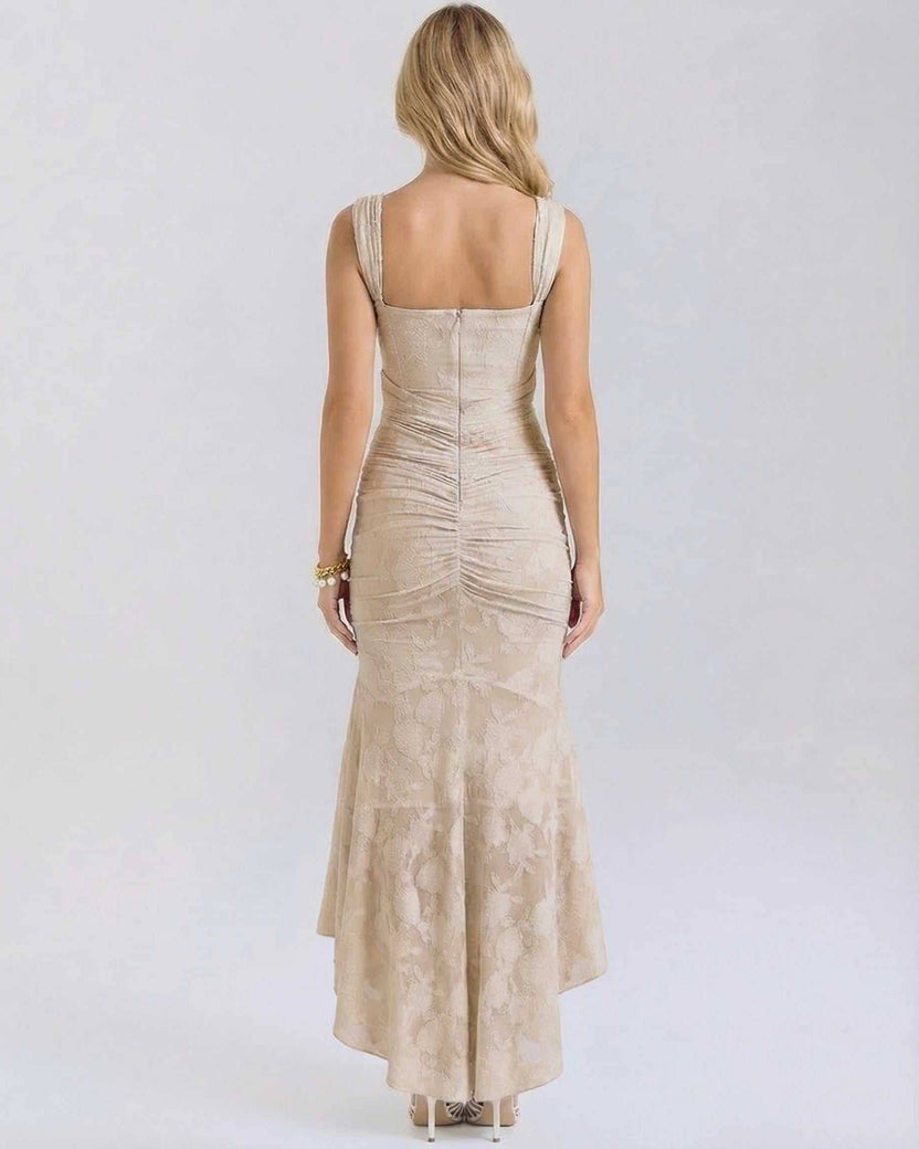 Back view of Sable Maxi Dress by Lauven featuring a ruched design and elegant fish tail hemline in nude.