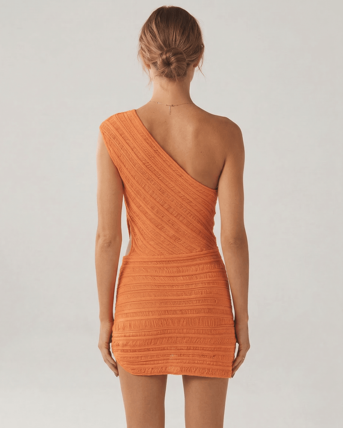 Saffron Mini Dress by Lauven, orange sheath silhouette with ribbed texture, showcasing the back design.