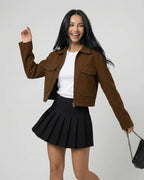 Women wearing Sahara Jacket by Lauven, a stylish brown jacket with a polo collar, paired with a black skirt.