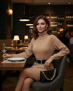 Sahara Mini Dress by Lauven - Beige ribbed long sleeve turtleneck mini dress styled in a chic restaurant setting.