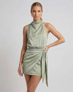 Sahara Mini Dress by Lauven - Elegant satin dress with draped high neck and wrap tie detail in soft sage green.