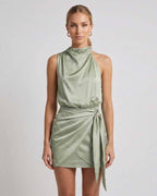 Sahara Mini Dress by Lauven, elegant satin mini dress with draped high neck and wrap tie detail in sage green.