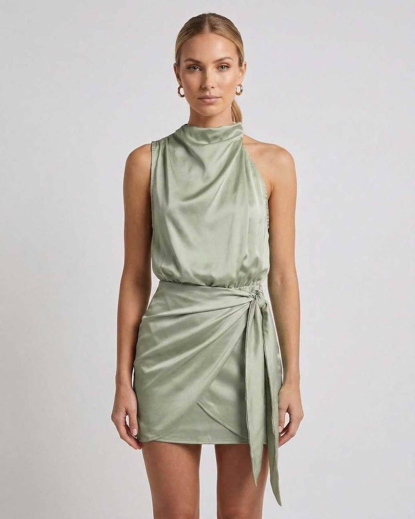 Sahara Mini Dress by Lauven, elegant satin mini dress with draped high neck and wrap tie detail in sage green.