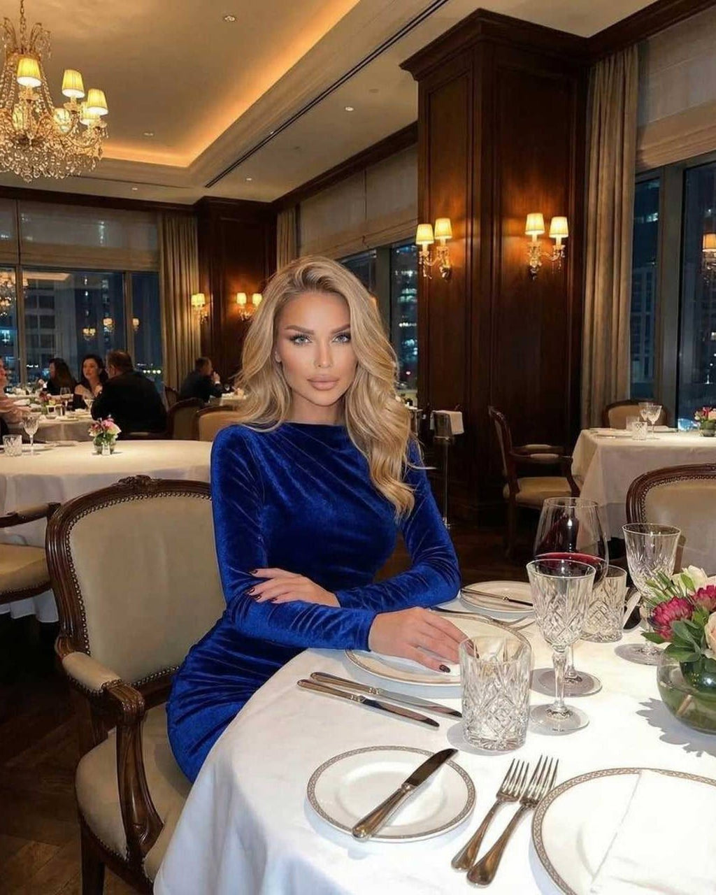 Sapphire Midi Dress by Lauven worn in an elegant restaurant setting, showcasing chic style and luxurious design.