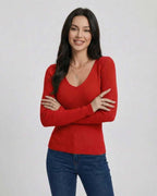 Women wearing the Scarlet Pullover by Lauven, a red V-neck sweater with a slim fit and long sleeves.