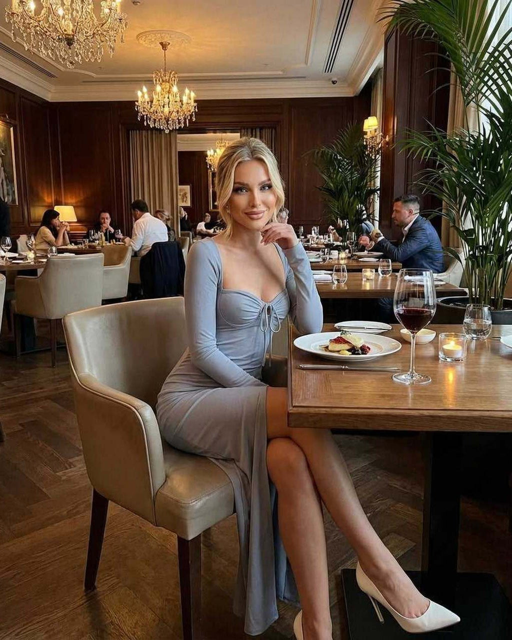 Selene Maxi Dress in light blue worn by a woman dining at an elegant restaurant, showcasing a classy evening gown style.