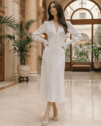 Selene Midi Dress in white, featuring a deep V-neck, long lantern sleeves, and elegant high-waist design by Lauven.