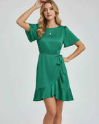 Lauven Selene Mini Dress with elegant ruffle detailing in rich emerald green, featuring a tie waist and satin-like finish.