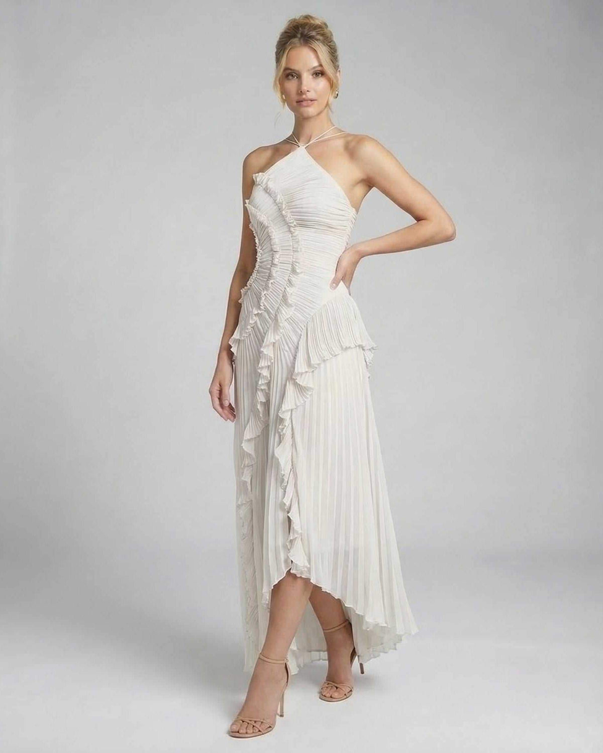 Seren Maxi Dress in ivory, pleated halter gown by Lauven with ruffles and high-low hem for elegant styling.