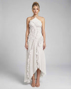 Seren Maxi Dress by Lauven, ivory pleated halter gown with ruffle accents and high-low silhouette.
