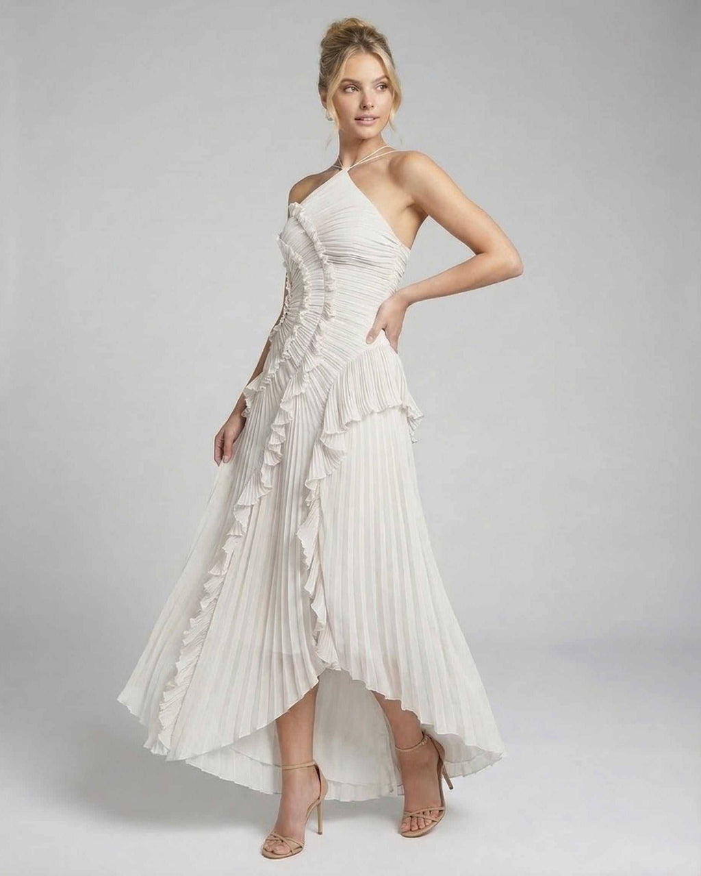 Seren Maxi Dress by Lauven, elegant ivory pleated halter gown with ruffles and high-low hem.