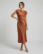 Seren Midi Dress - Elegant satin gown with twisted-back, cutout detail, rich rust color from Lauven. Effortlessly sophisticated.