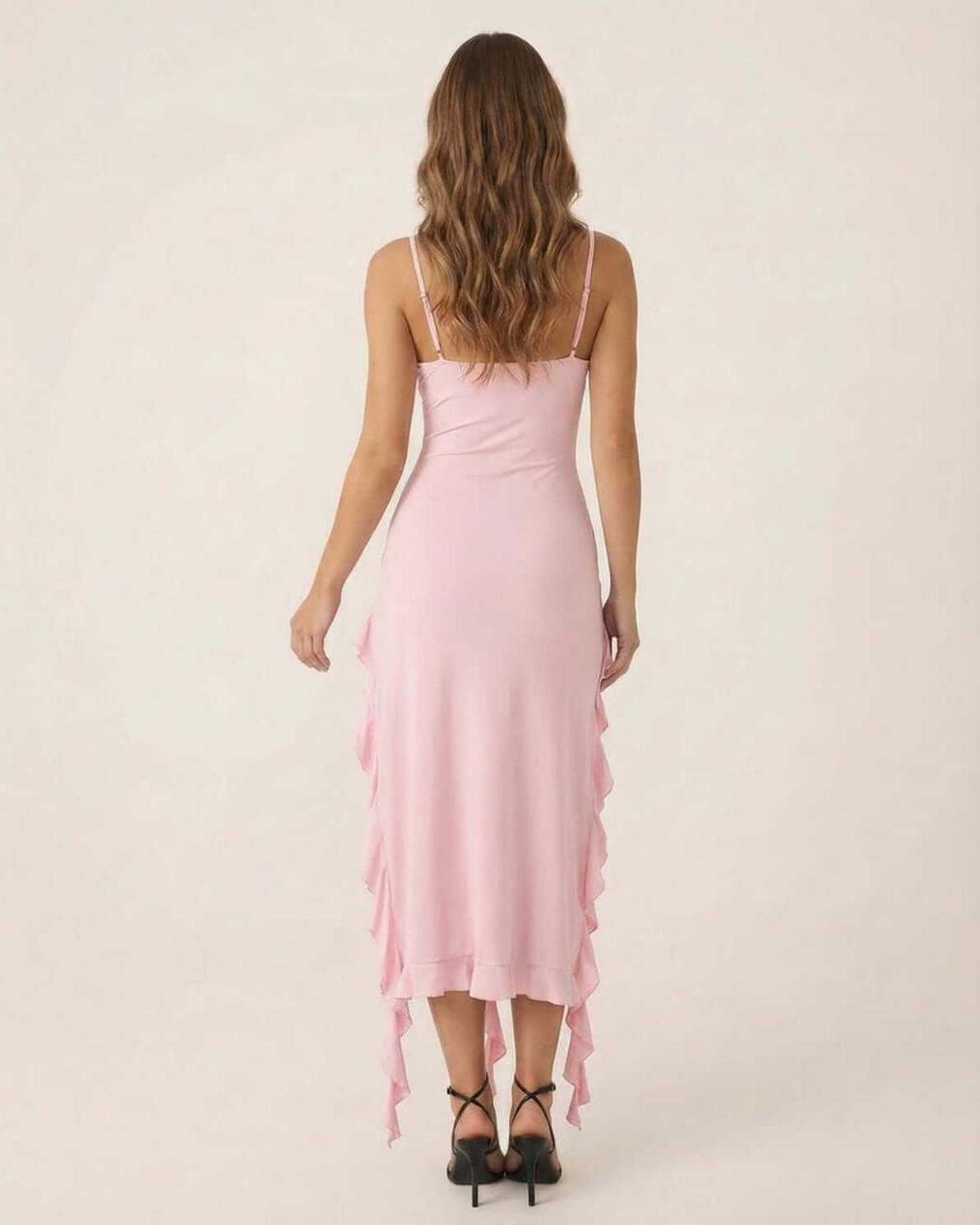 Back view of the Seren Midi Dress by Lauven in soft pink with flirty ruffle trim and spaghetti straps.