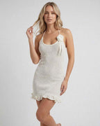 Serena Mini Dress by Lauven in cream with halter neck and ruffle hem, showcasing a feminine look.