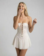 Serena Mini Dress by Lauven, strapless ivory corset mini dress with flared skirt and lace-up detail.