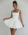 Model wearing Lauven Serena Mini Dress, an elegant white square collar camisole dress with flared skirt.