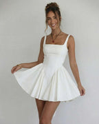 Model wearing Lauven Serena Mini Dress, an elegant white square collar camisole dress with flared skirt.