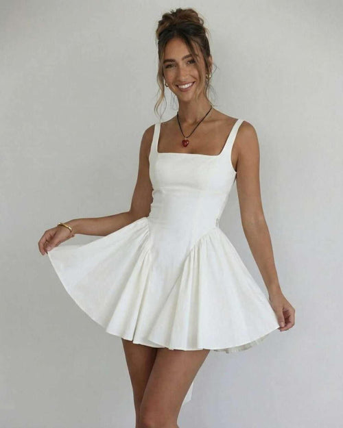 Model wearing Lauven Serena Mini Dress, an elegant white square collar camisole dress with flared skirt.