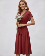 Serene Midi Dress in a warm rust shade, featuring a V-neck and pleated fabric, styled with a self-tie belt by Lauven.