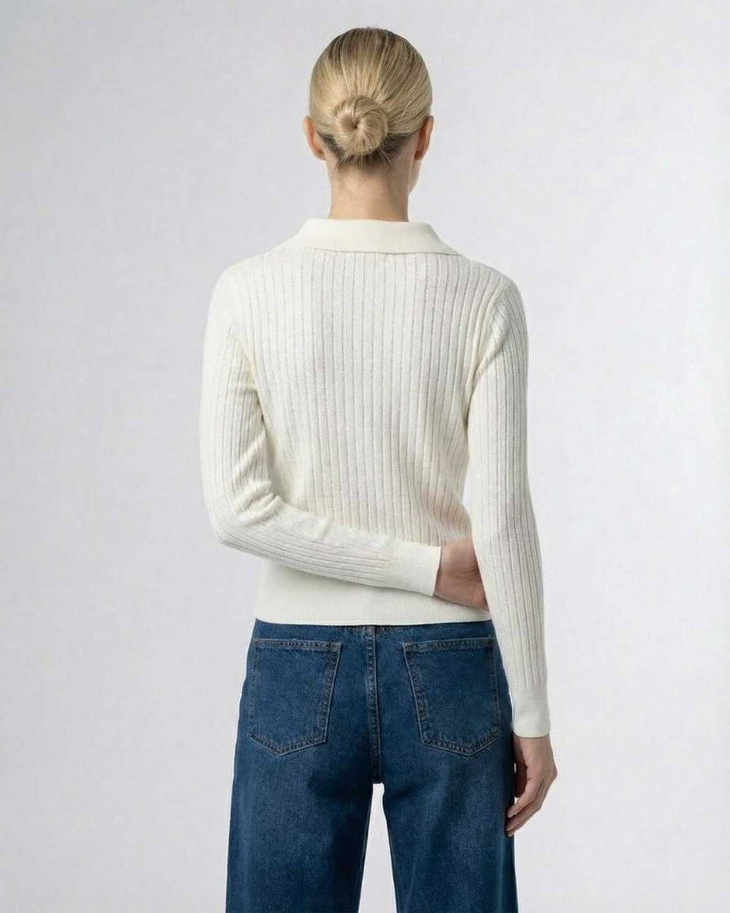 Back view of a woman wearing the Sienna Cardigan by Lauven, showcasing its ribbed texture and elegant collar.