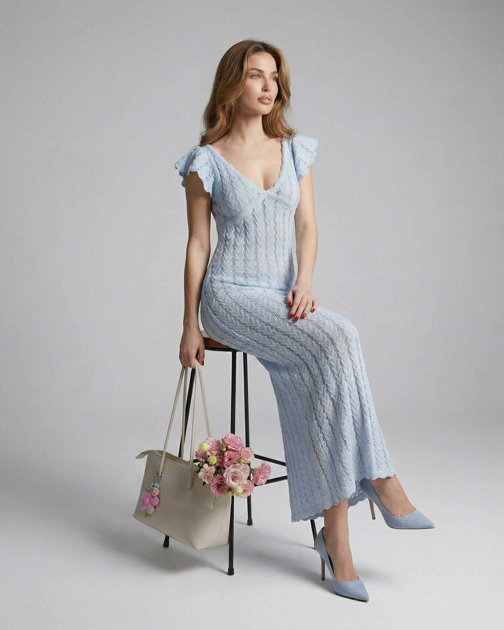 Sienna Maxi Dress by Lauven, featuring light blue lace, V-neck, ruffle sleeves, styled with a handbag and flowers.