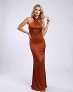 Sienna Maxi Dress in rust satin with halter neck and open back, by Lauven, perfect for elegant occasions.