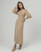 Sienna Midi Dress by Lauven, a beige long sleeve A-line dress with V-neck and high waist, embodying elegance.