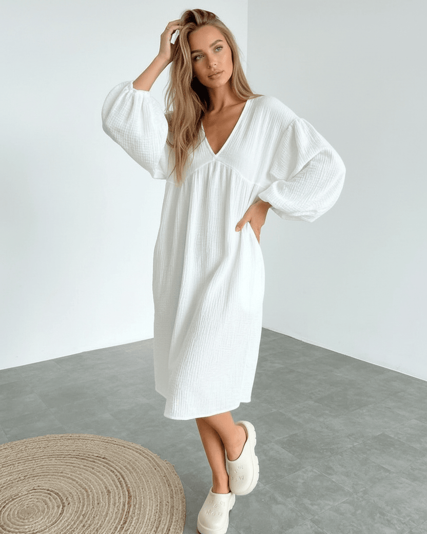 Sienna Midi Dress featuring puff sleeves and white cotton fabric, combining comfort and elegance from Lauven.