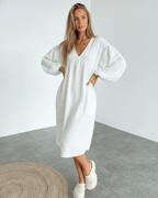 Sienna Midi Dress in white cotton with puff sleeves, offering effortless elegance and modern femininity by Lauven.