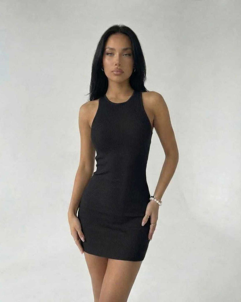 Model wearing the Sienna Mini Dress by Lauven in black ribbed knit, showcasing a sleek and modern sleeveless bodycon style.