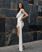 Sienna Mini Dress by Lauven, featuring draped backless design and elegant pleating in smooth white silk fabric.