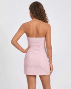 Back view of Sienna Mini Dress by Lauven, a strapless gingham summer dress in soft pink.