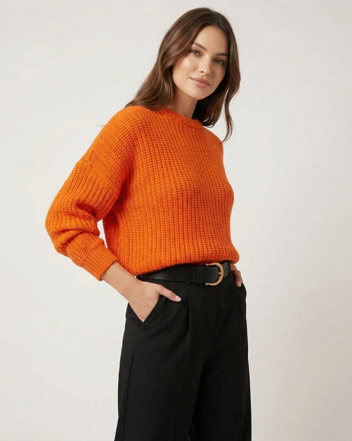 Sienna Sweater by Lauven in bright orange knit texture worn with black pants for a polished casual look.