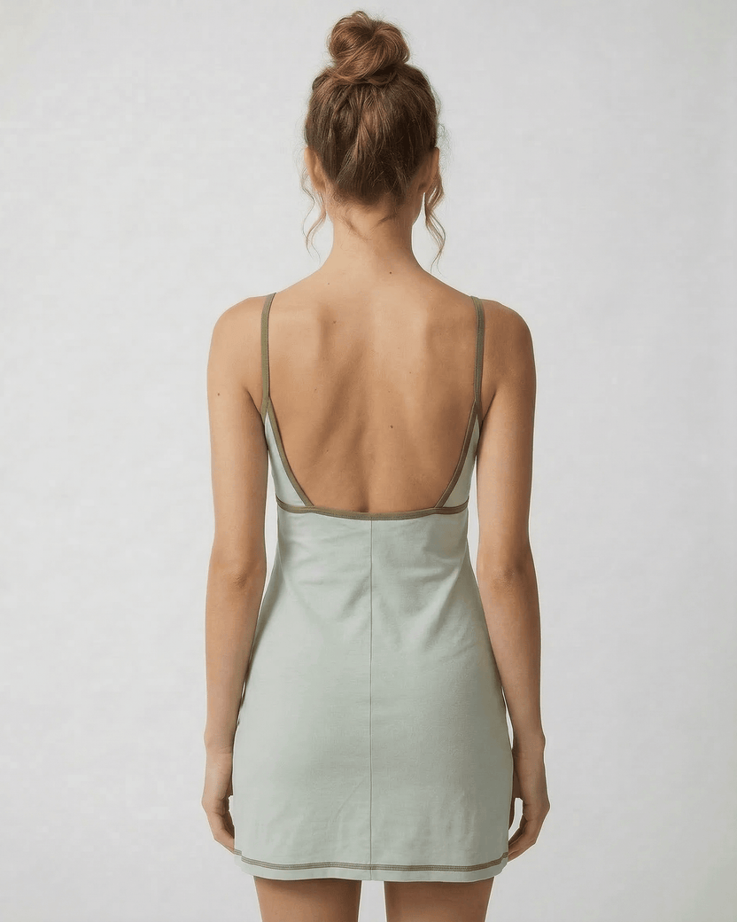 Sierra Mini Dress by Lauven showcasing an olive-trimmed back cut-out detail in pastel green.