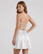 Model wearing the Silver Satin Mini dress by Lauven, featuring delicate spaghetti straps and a laced back design.