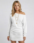 Model wearing Lauven Snowfall Mini Dress, featuring adjustable side drawstrings and a relaxed fit in white.