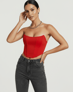 Model wearing Solara Corset Top by Lauven in vibrant red velvet with structured silhouette.