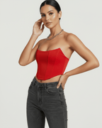 Model wearing Solara Corset Top by Lauven in vibrant red velvet, showcasing structured silhouette and modern design.