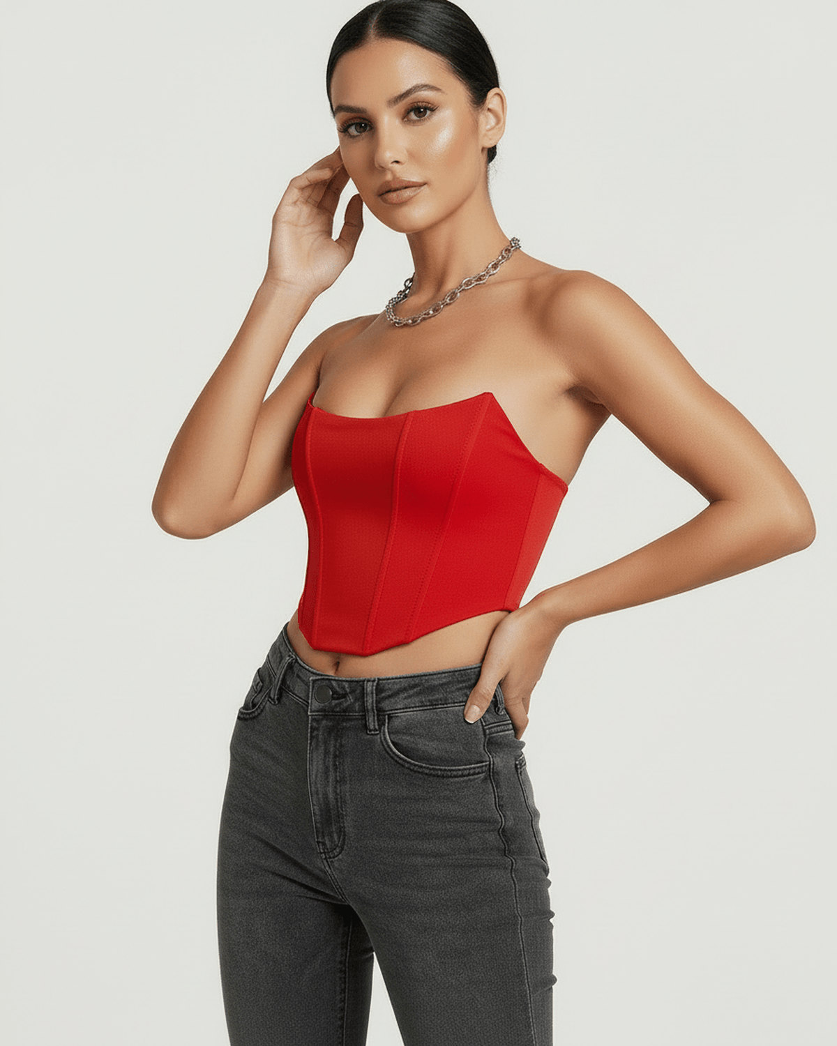 Model wearing Solara Corset Top by Lauven in vibrant red velvet, showcasing structured silhouette and modern design.