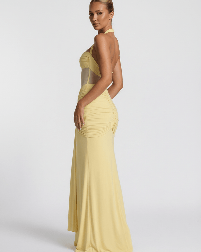 Solara Maxi Dress featuring a yellow halter design, mesh panel, and mermaid silhouette by Lauven.