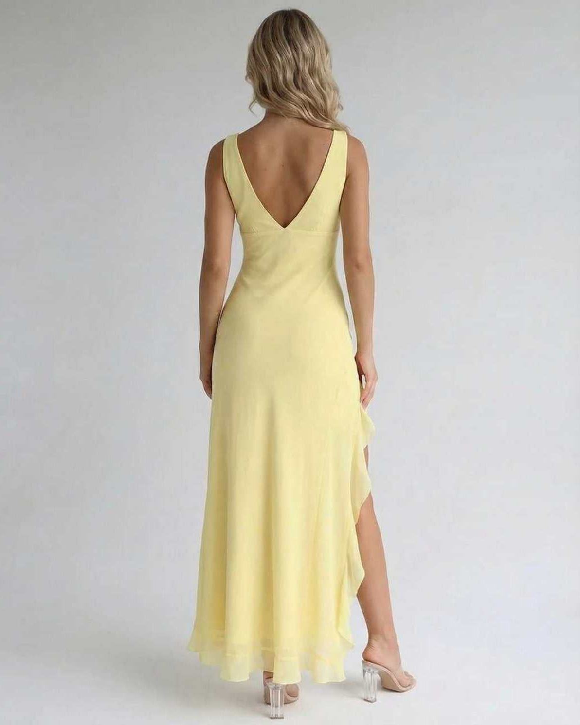 Solara Maxi Dress showcasing the elegant yellow fabric, ruffle slit, and flowing silhouette by Lauven.