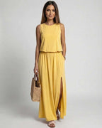 Solara Maxi Dress in vibrant yellow with sleeveless silhouette, side slit, and flowing comfort from Lauven.