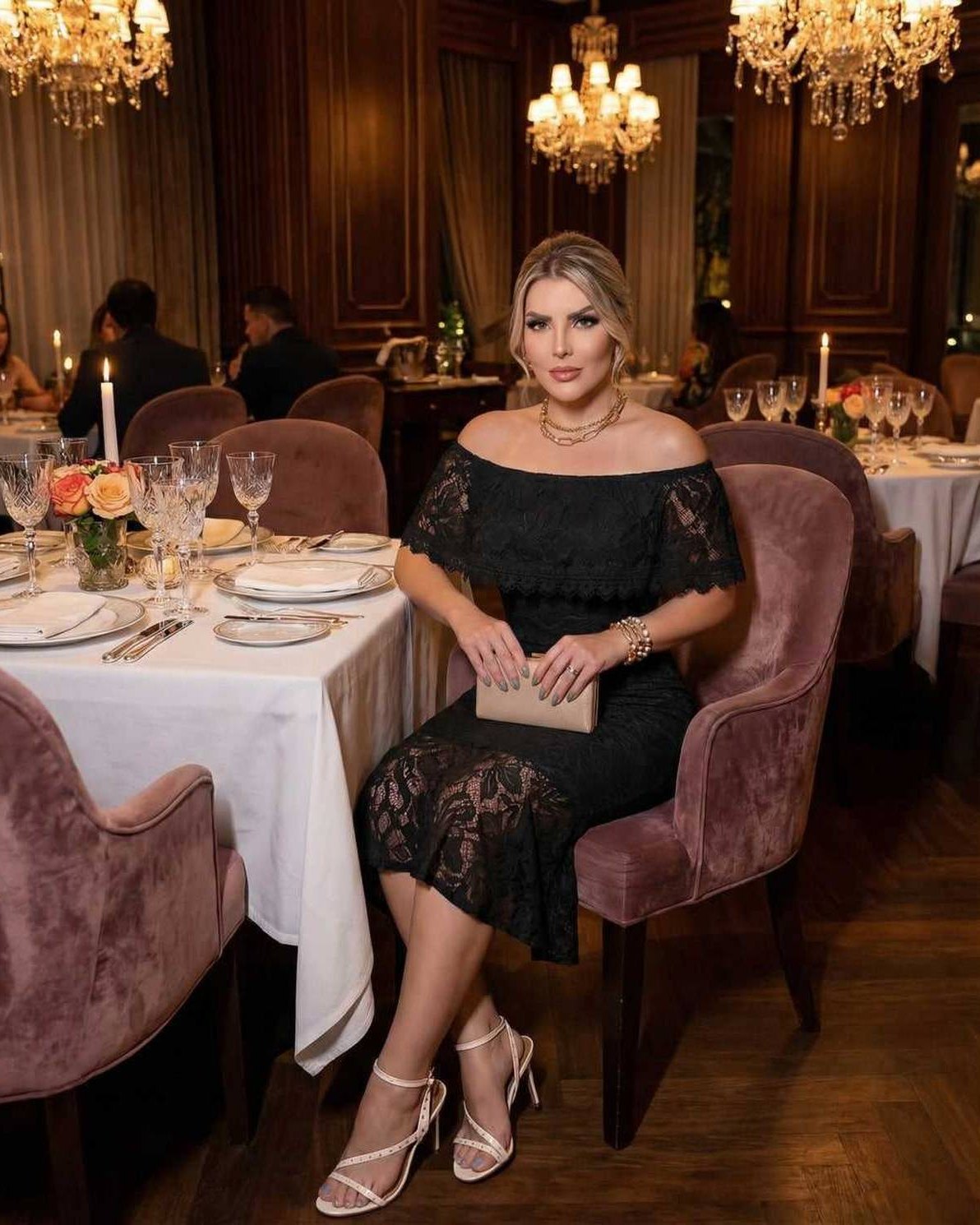 Elegant woman wearing Solara Midi Dress by Lauven with off-the-shoulder lace design in a fine dining setting.