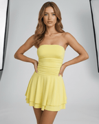 Solara Mini Dress by Lauven in soft yellow, showcasing a strapless and stylish club look.