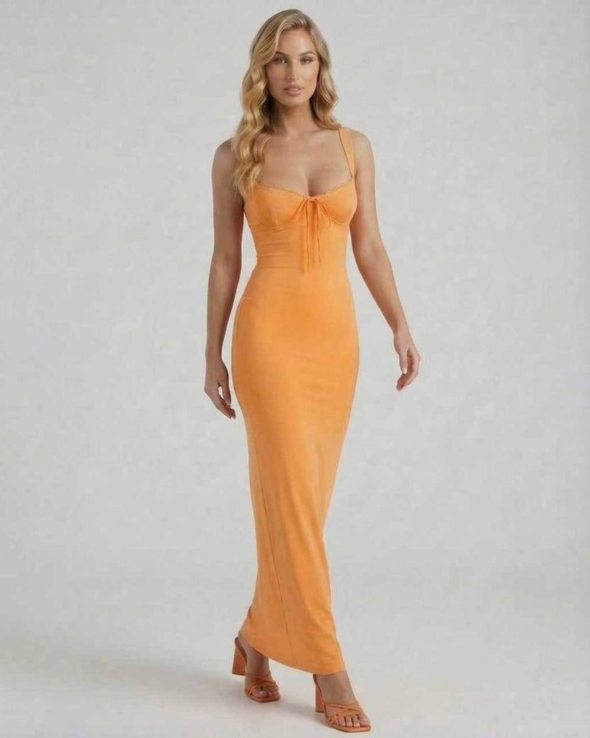 Model wearing the Lauven Soleil Maxi Dress in vibrant orange, featuring spaghetti straps and lace trim.