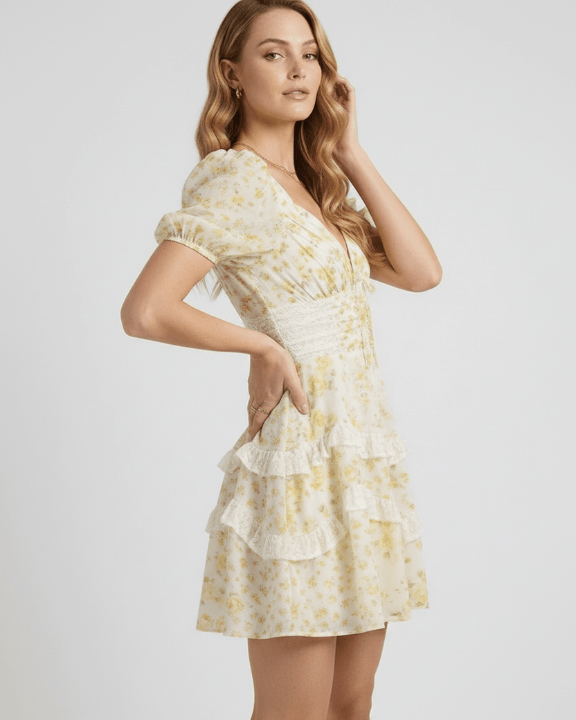 Soleil Mini Dress showcasing soft floral print, tiered ruffles, and elegant A-line silhouette by Lauven.