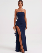 Model wearing Solenne Maxi Dress by Lauven showcasing a bandeau design, dramatic side slit, and smooth polyester fabric.